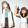 Two figures together. The Alien Party Advisor looking concerned stands next to Miyu who strikes a defiant pose pointing into the air.