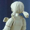 Back of the unpainted posable figure of Yuri in her Alien Party outfit. Her arms have been moved inwards to show the posable aspect.